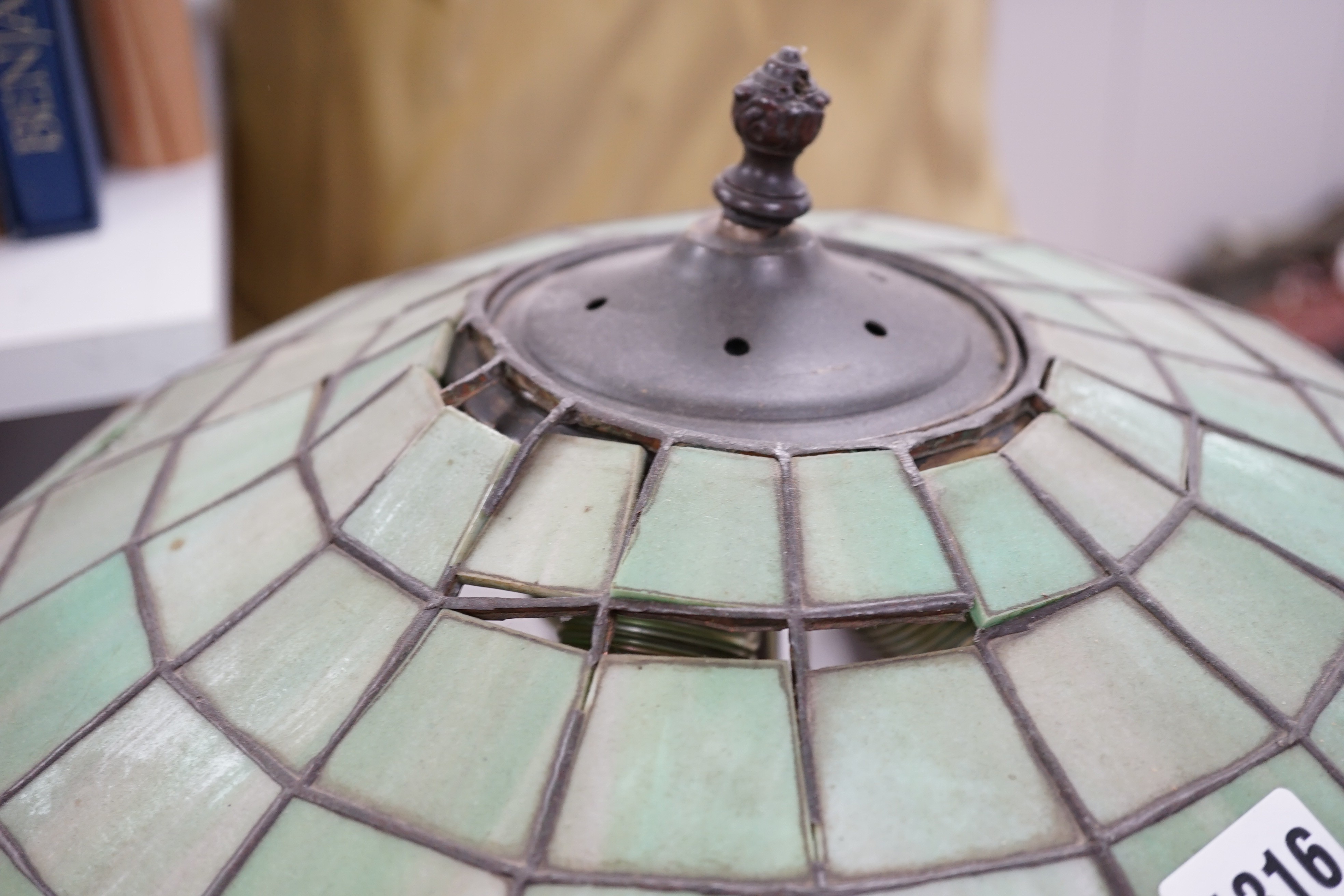A spelter lamp with Tiffany style shade, 57cms high including shade